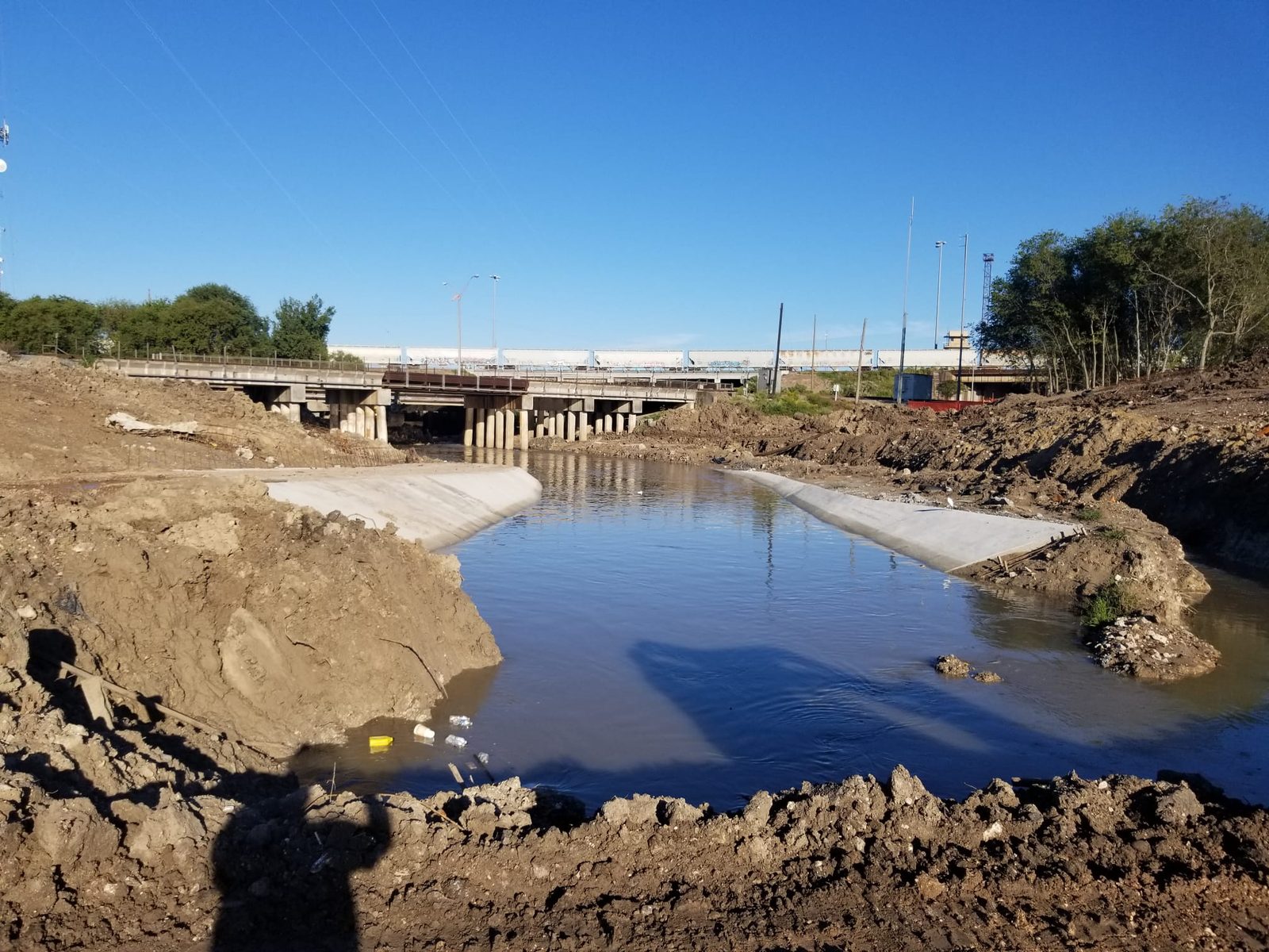 Ground-level view of the Hunting Bayou channel and bridge crossing