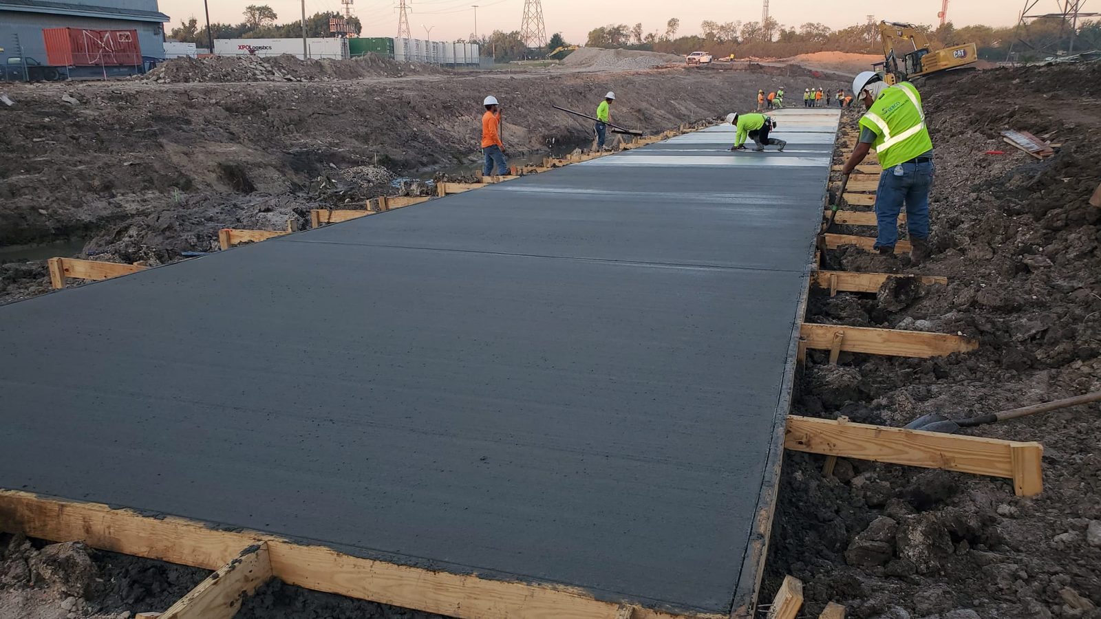 Crew placing and finishing a concrete channel slab on Hunting Bayou