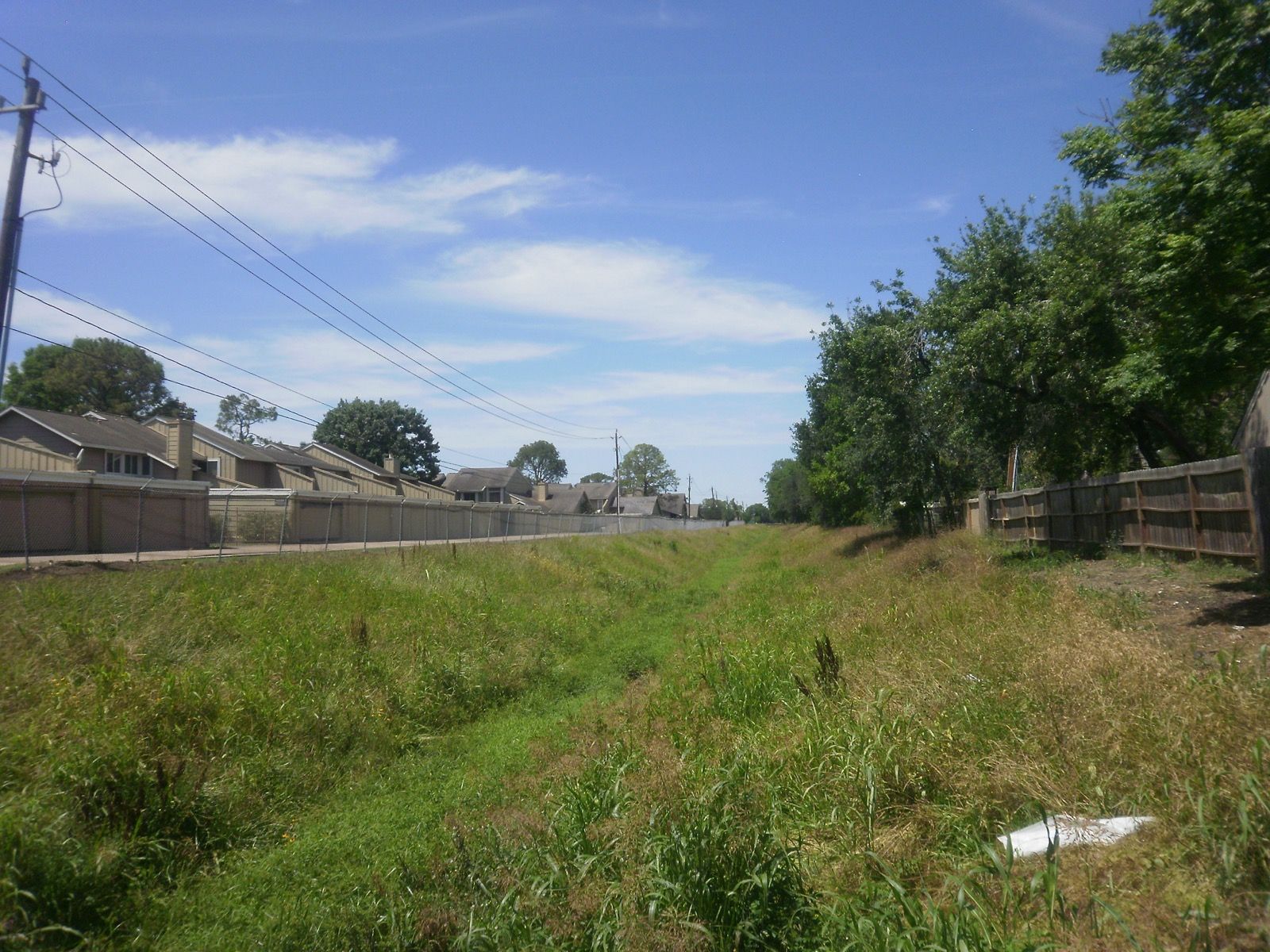 Utility easement corridor between residential fence lines
