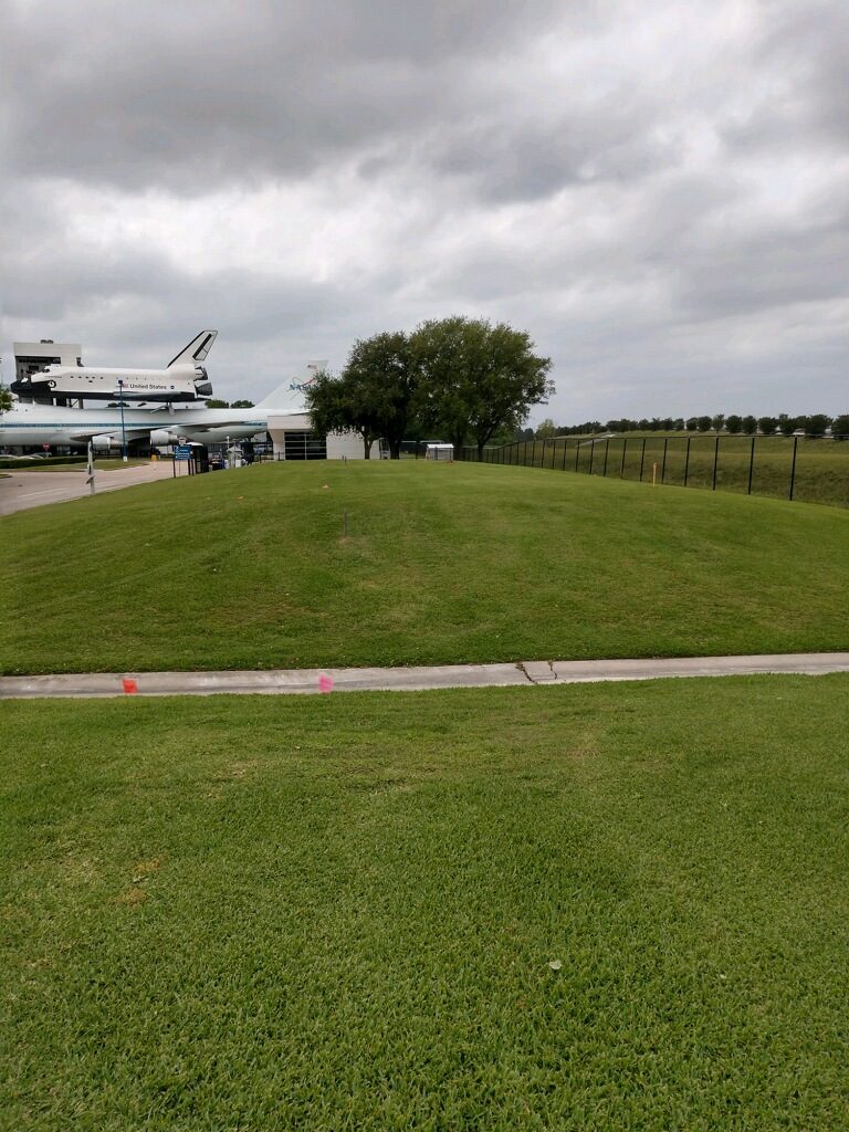 Open lawn on the NASA campus with Space Center Houston exhibits beyond