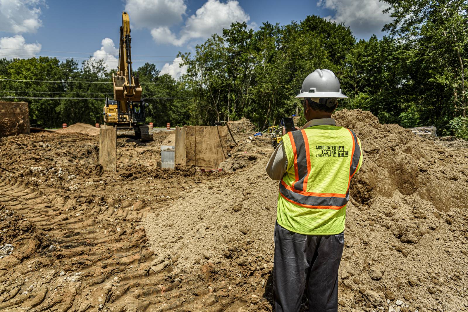 ATL technician observing excavation work along the water line corridor