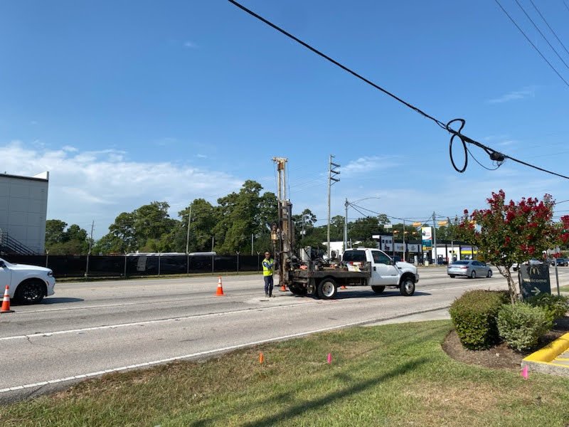 Wide view of the Will Clayton Parkway corridor with the drill rig on the shoulder
