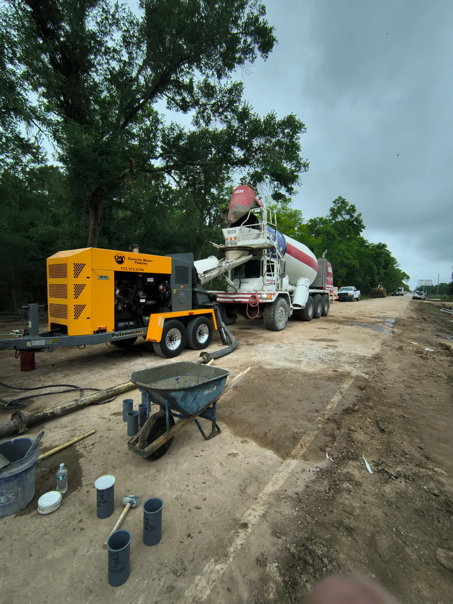 Concrete mixer truck and pump on a construction site